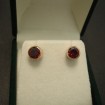 neat-gold-earstuds-4mm-garnets-04766.jpg